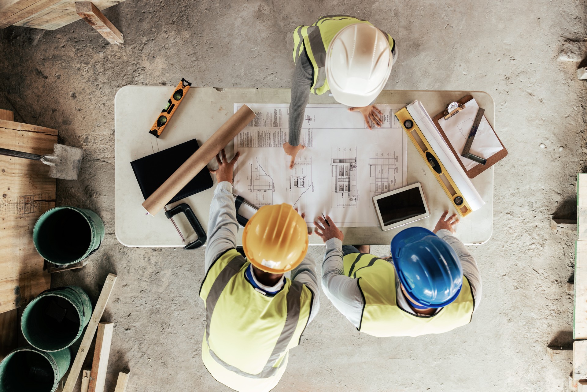 Top view, construction workers or blueprint planning in house, home or office building in real estate, property or architecture innovation. Men, engineering woman or construction site people or ideas